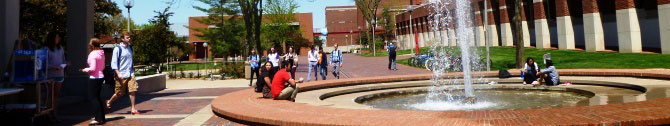 Student by the fountain on the campus mall