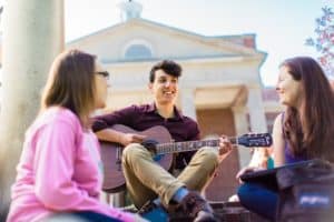 student playing a guitar