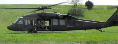 Helicopter landing in a field