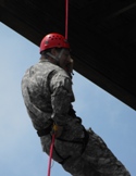 Student climbing with a rope