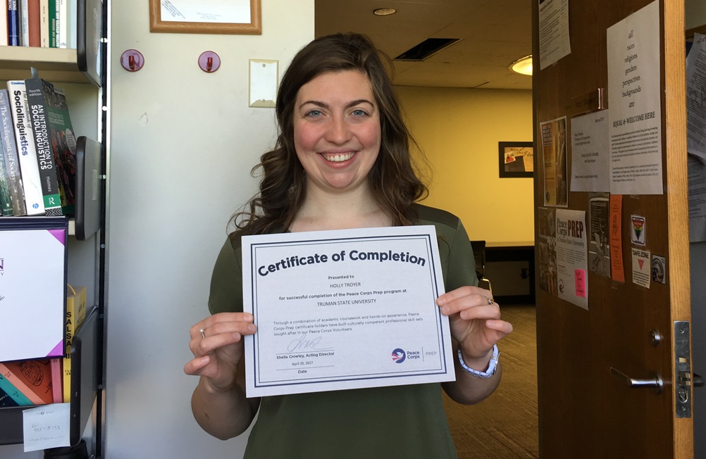 Holly Troyer with her Certificate of Completion for the Peace Corps Prep Program