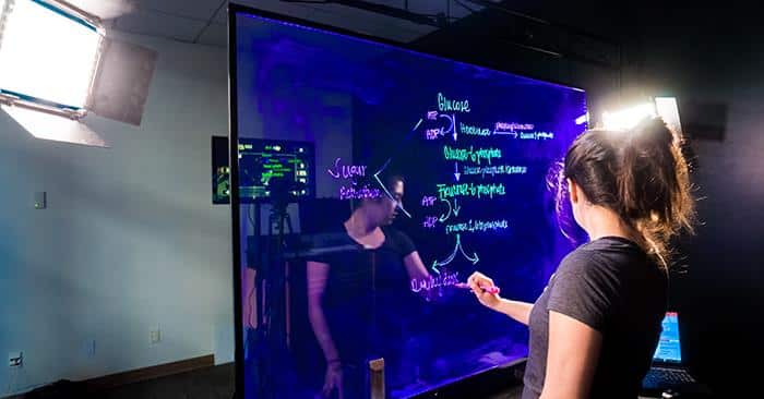 Girl using the Lightboard Studio