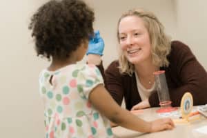 Student working with a young girl in Speech and Hearing Clinic