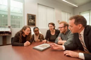 Studying ancient book in Special Collections in Pickler Memorial Library