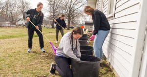 Students raking leaves as part of the Big Event