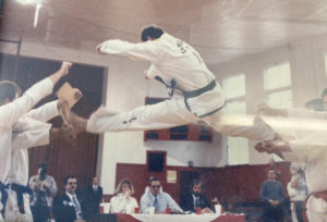 Mike Crager breaking boards at a Taekwondo tournament.